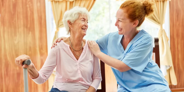 An aged care worker positively supporting an elderly woman