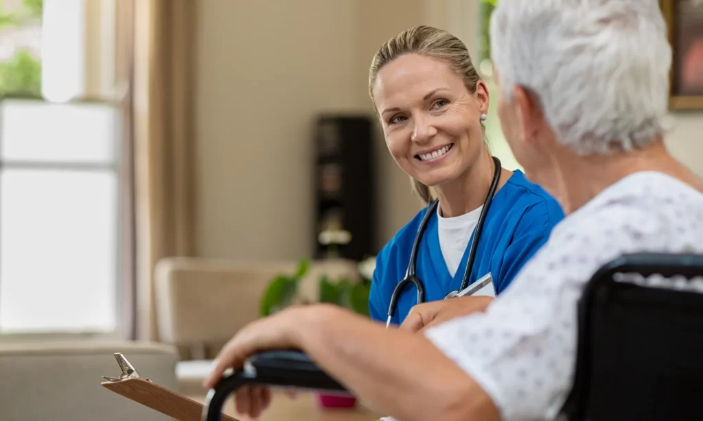 An aged care worker smiling at a male patient